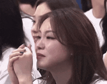 a woman with a ring on her finger is crying