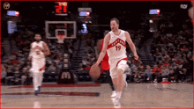 a basketball player with the number 19 on his jersey is dribbling a basketball