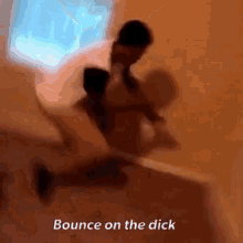 a blurry picture of a person sitting on a bed with the words `` bounce on the dick '' .