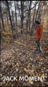 a man in a red jacket is standing in the woods with the words " jack moment " above him