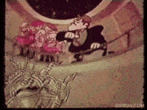 a gif from gifrun.com shows a man in a tuxedo talking to a group of people
