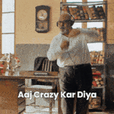 a man wearing headphones is dancing in front of a bookshelf with the words aaj crazy kar diya above him