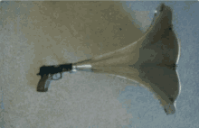 a gun with a long horn attached to it on a carpet