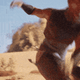 a blurred image of a man standing in the desert