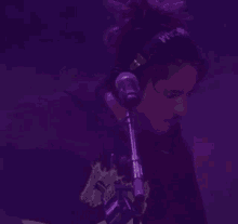 a person wearing headphones is singing into a microphone ..
