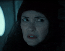a close up of a woman 's face in the dark