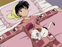 a girl is laying on a bed with a cat on her shoulder