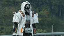 a person in a white and black costume with an orange belt