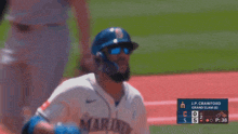 a baseball player wearing sunglasses and a helmet with the word marines on his jersey