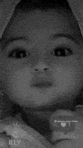 a black and white photo of a baby with the name aggimehra