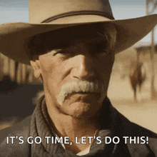 a man with a cowboy hat and mustache is saying it 's go time let 's do this