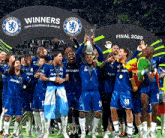 a group of soccer players are holding up a trophy in front of a sign that says winners