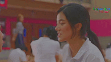 a boy and a girl are standing next to each other on a basketball court .