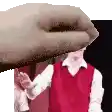 a man in a red vest is standing in front of a hand .