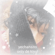 a woman is covering her face with a scarf and the words yechansito only de kiyu are visible behind her .