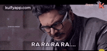 a man wearing glasses and a leather jacket is crying and saying `` ra ra ra ra ... '' .