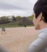 a man is watching a baseball game being played
