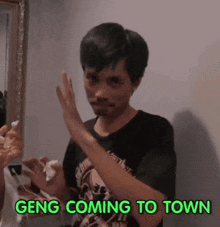 a man in a black shirt says gang coming to town in green text