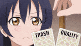 a girl is looking at two cards that say trash and quality on them