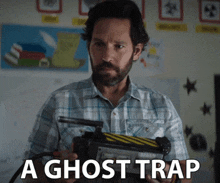 a man in a plaid shirt holds a ghost trap