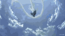 a person is flying through a cloudy blue sky