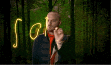 a man with a beard is writing the word sodia with glowing lights