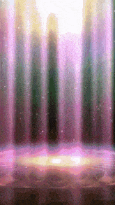 a stage with a purple curtain behind it and a light shining through it