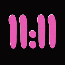 a black background with pink numbers and sprinkles that says 11:11