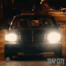 a movie poster for trap city shows a car driving down a street at night