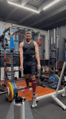a man lifting a barbell in a gym with a rogue barbell
