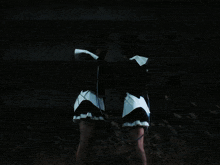 a person in a white shirt is holding a string between their hands