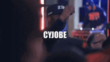 a man in a hat with the word cyjobe written on it