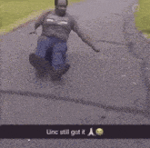 a man is riding a skateboard down a road while wearing glasses .