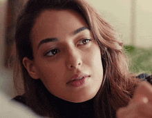 a close up of a woman 's face looking at the camera