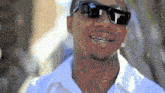 a man with a tattoo on his neck wearing sunglasses and a white shirt