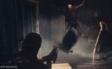 a man holding a gun in a video game with ign written on the bottom right