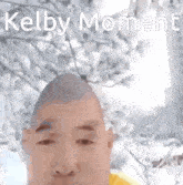 a picture of a bald man with kelby moment written on it