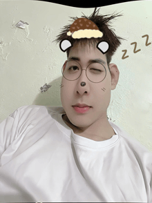 a young man wearing glasses has a drawing of a bear on his head and the word zzz written on the wall