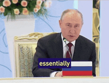 a man in a suit and tie is sitting at a table with a sign that says essentially