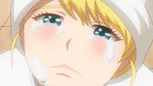 a girl with blonde hair and blue eyes is crying
