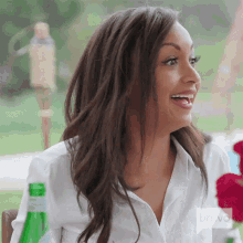 a woman wearing a white shirt with bravo written on the bottom