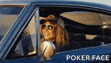 a woman wearing sunglasses and a hat is sitting in a car with poker face written on the bottom