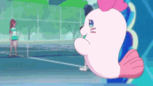 a pink seal is standing on a tennis court next to a girl .