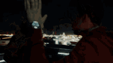 a man and a woman giving each other a high five at night