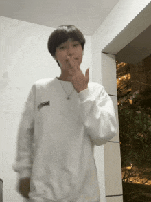 a young man wearing a white sweatshirt with the word snoopy on it