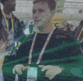 a man with a lanyard around his neck is talking to a woman