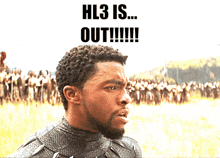 a man stands in front of a crowd with the words " hl3 is out !!! " above him