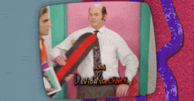 a man in a white shirt and tie with the name david koechner