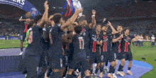 a group of soccer players holding up a trophy with the number 17 on the back of their jersey