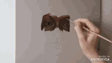 a painting of a woman 's face is being made in animotica